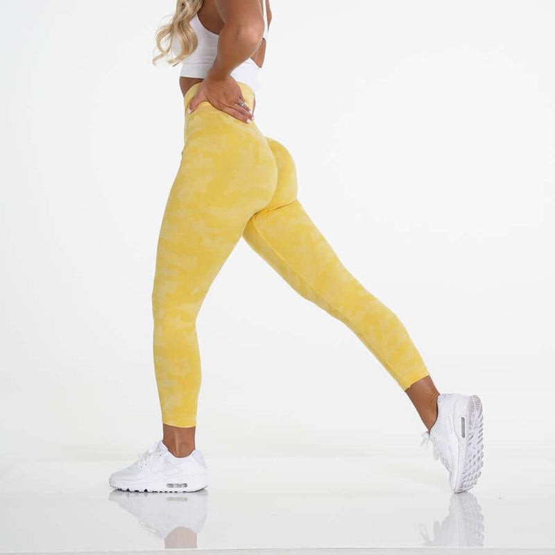 Brand Name yellow yoga leggings worn by model, showcasing comfort and flexibility during workout.