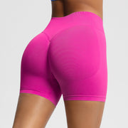 Pink athletic shorts on a plain background