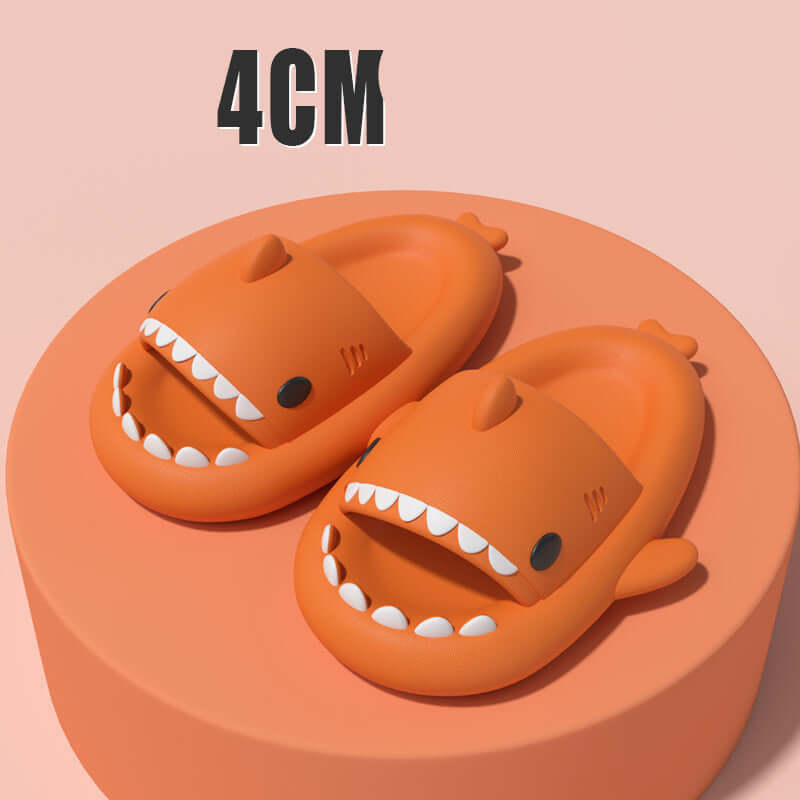 Sharky slippers with cartoon shark design, showcasing comfort and fun for indoor/outdoor use, resting on a display.