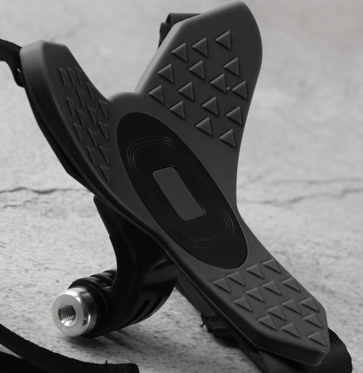Black scooter foot pegs with textured surface on a gray background