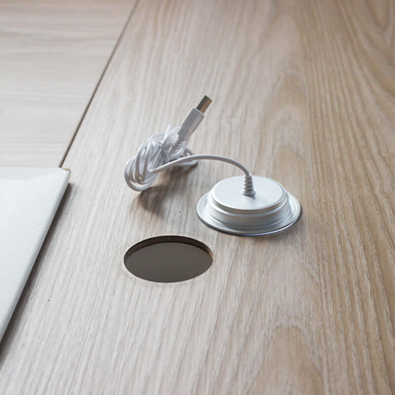 Small desk lamp with cord on a wooden surface