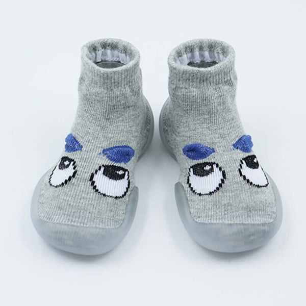 Pair of gray socks with cartoon face design on a white background