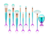 Makeup brushes with mermaid tail design on a white background