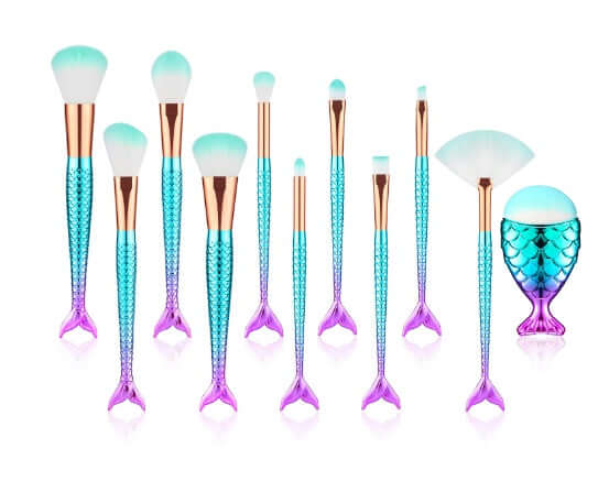 Makeup brushes with mermaid tail design on a white background