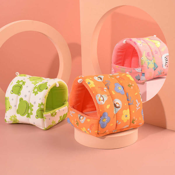 Three colorful pet dens with animal patterns on a pink background