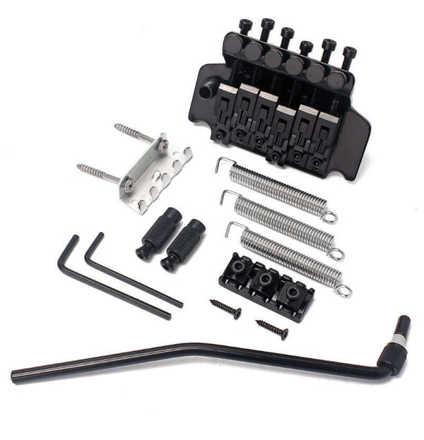 Guitar bridge assembly with components on a white background