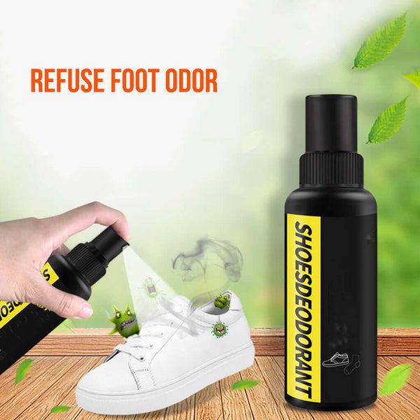Shoe deodorant spray being used on a white sneaker with green leaves in the background.