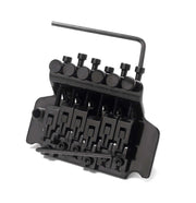 Black guitar bridge with a wrench on a white background
