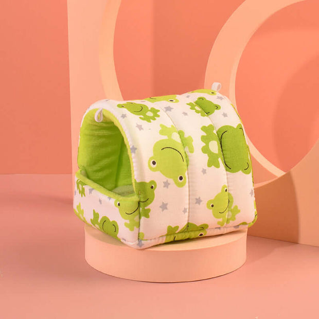 Pet bed with green frog pattern on a pink background
