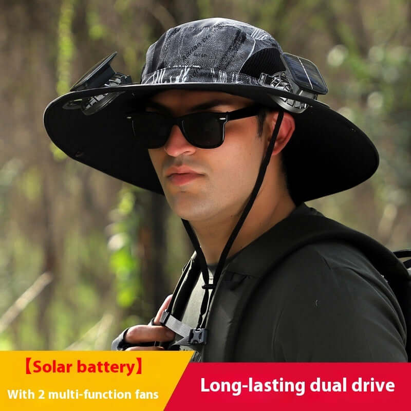 Person wearing a black hat with solar panels and fans, outdoors.