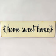 Wooden sign with 'home sweet home' text on a white background
