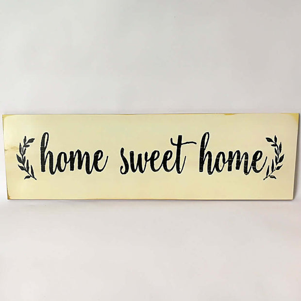 Wooden sign with 'home sweet home' text on a white background