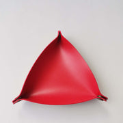 Red triangular wall hook on a white background