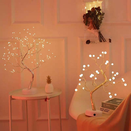 Decorative LED trees with warm lighting in a room setting.