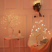 Decorative LED trees with warm lighting in a room setting.