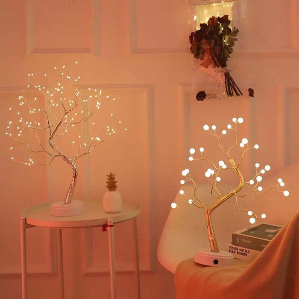 Decorative LED trees with warm lighting in a room setting.
