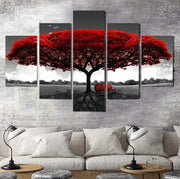 Five-panel wall art of a red tree with a bench underneath, displayed above a sofa.