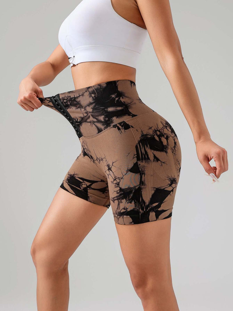 Tie dye button summer sports shorts showcasing a woman's figure with high-waisted design for a flattering fit.