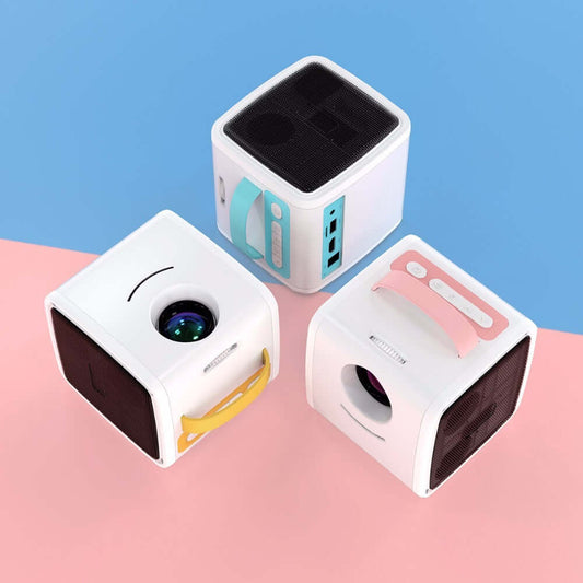 Three small cube-shaped devices on a pink and blue background