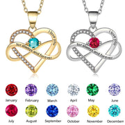 Two heart-shaped necklaces with colored gemstones and engraved text on a white background.