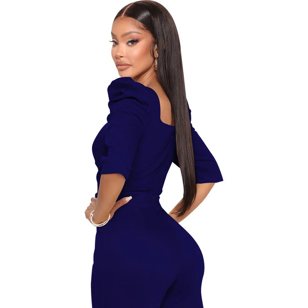 Woman wearing a blue jumpsuit on a white background