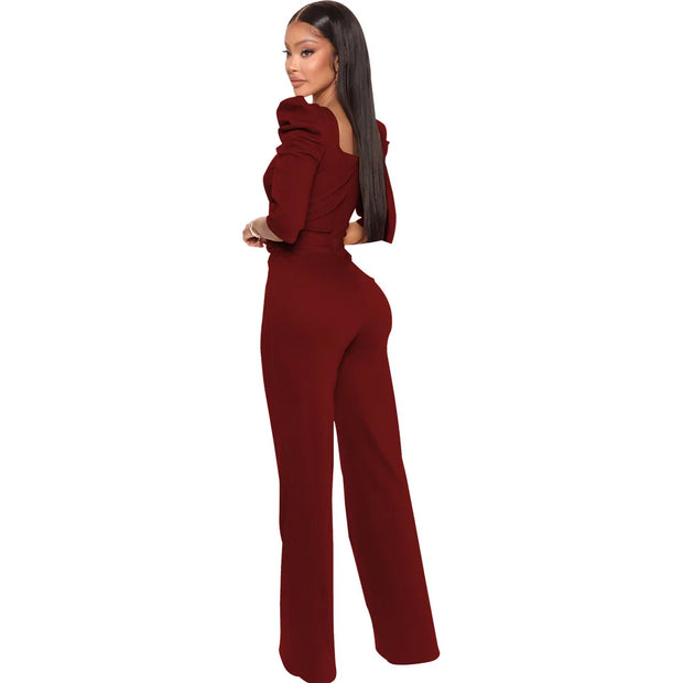 Woman wearing a maroon jumpsuit on a white background