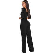 Woman wearing a black jumpsuit on a white background