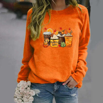 Person wearing an orange sweatshirt with autumn-themed graphics and text.