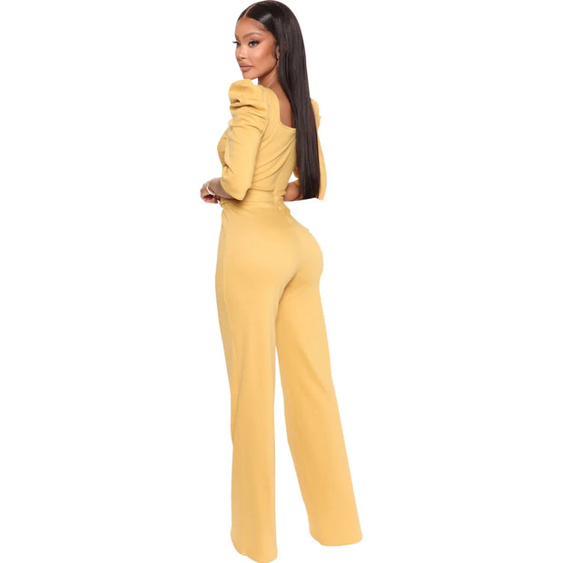 Woman wearing a yellow jumpsuit on a white background
