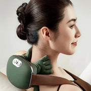 Woman using a green neck and shoulder massager on a plain background