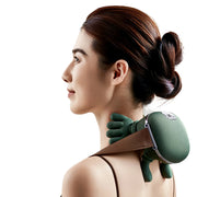 Woman using a green neck and shoulder massager on a white background