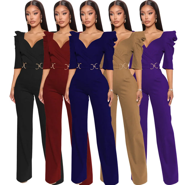 Five women wearing jumpsuits in black, red, blue, brown, and purple on a white background.