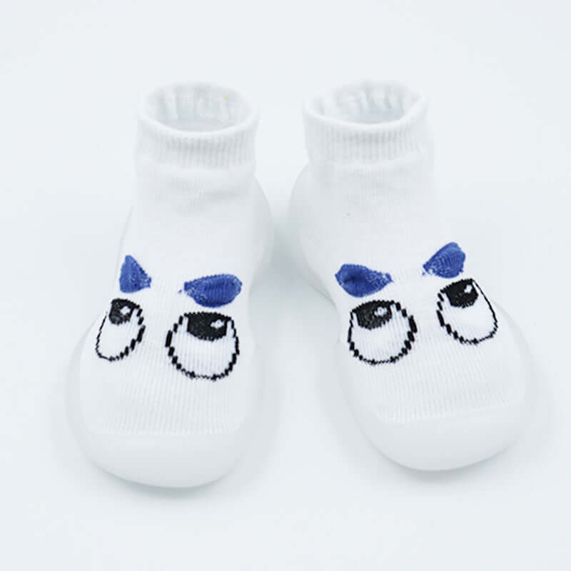 Pair of white socks with cartoon face design on a light gray background