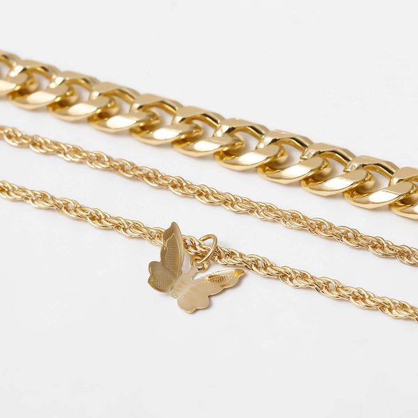 Three gold chains with a bird-shaped pendant on a white background