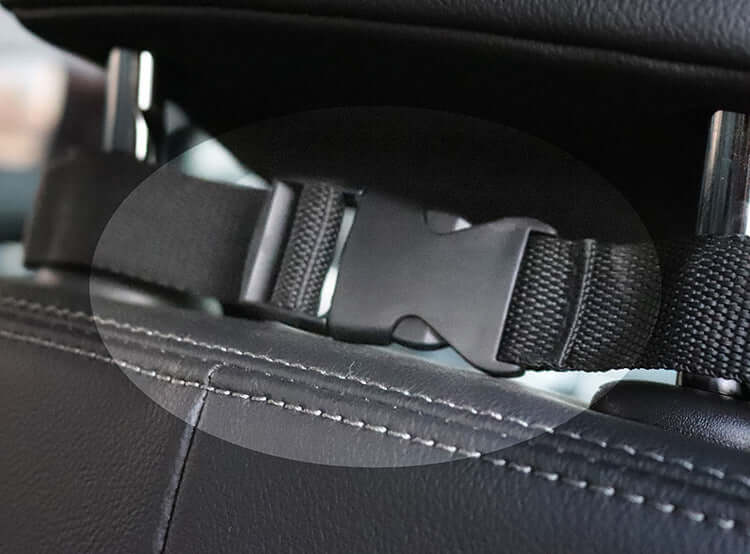 Close-up of a car seat belt buckle in a vehicle interior.
