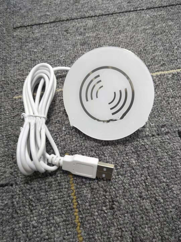 Small electronic device with USB cable on a textured surface