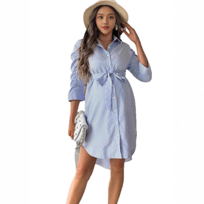 Woman wearing a blue and white striped dress with a hat on a white background