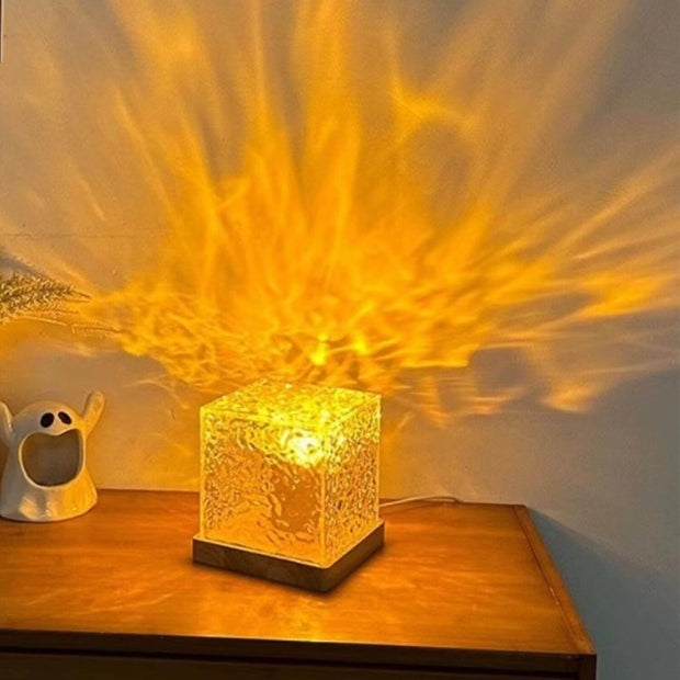Decorative lamp casting a warm glow on a wooden surface with a blurred background