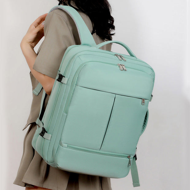 Person wearing a light blue backpack on a plain background