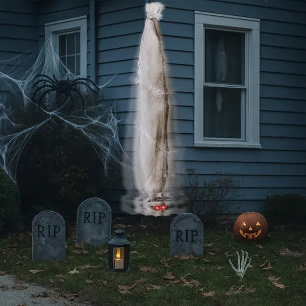 Halloween-themed outdoor scene with ghost, tombstones, and pumpkin in front of a house.