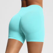 Turquoise athletic shorts worn by a person on a plain background