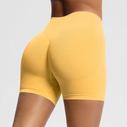 Yellow athletic shorts worn by a person on a light gray background