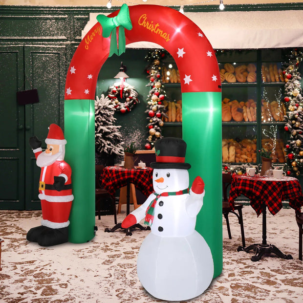 Inflatable Christmas arch with Santa Claus and snowman decorations in a festive setting.