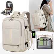 Beige backpack with multiple compartments and charging port, shown with a person using it.