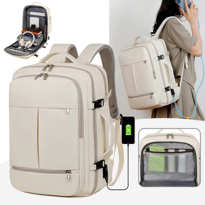 Beige backpack with multiple compartments and charging port, shown with a person using it.