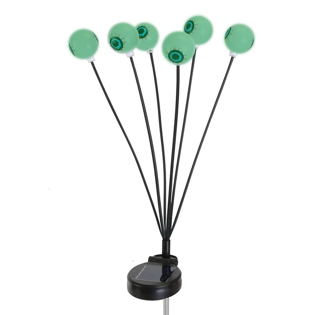 Solar-powered LED light with green eyeball designs on a white background