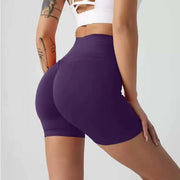 Person wearing purple athletic shorts on a plain background