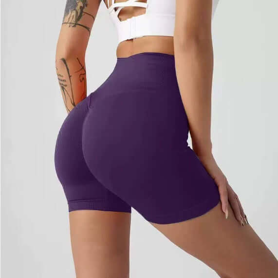 Person wearing purple athletic shorts on a plain background