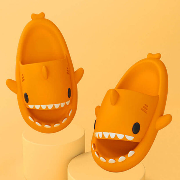 Cartoon shark slippers in orange for adults, showcasing fun indoor/outdoor design and comfortable fit.