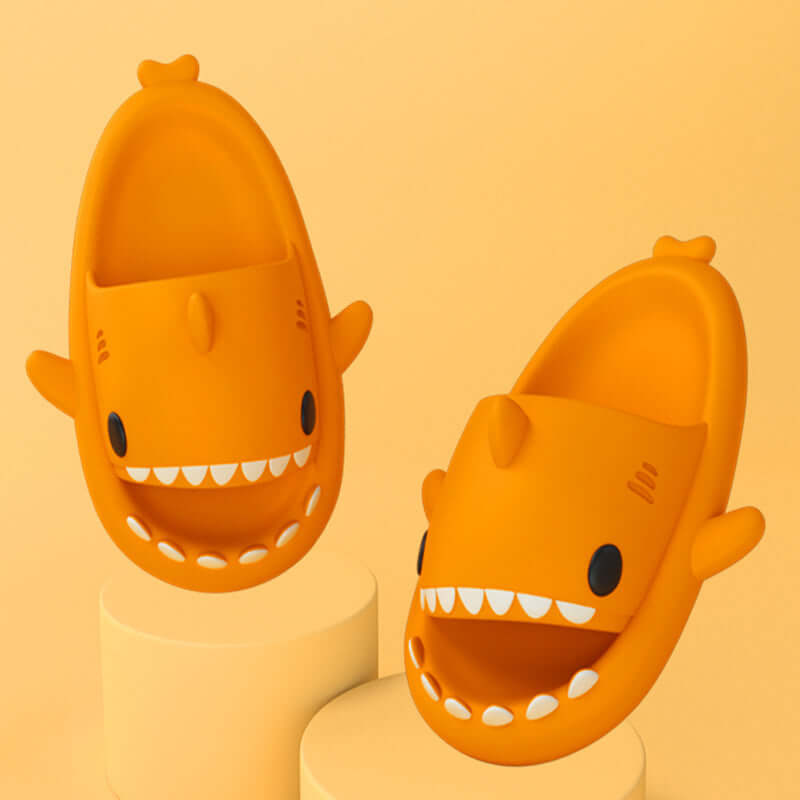 Cartoon shark slippers in orange for adults, showcasing fun indoor/outdoor design and comfortable fit.